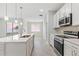 Bright kitchen featuring stainless appliances, center island and a light-filled open floor plan at 3294 Gowanda Ave, North Port, FL 34287