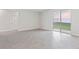 Neutral living space featuring sliding glass doors to the backyard and beautiful tile flooring at 3294 Gowanda Ave, North Port, FL 34287