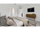 Spacious bedroom with ensuite bathroom access, a TV, and modern decor at 3294 Gowanda Ave, North Port, FL 34287