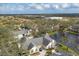 Aerial view of a home with a pond, lush greenery, and neighboring properties at 4563 Whirlaway Dr # C, Sarasota, FL 34233