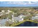 Panoramic aerial view showcasing the tranquil community surrounded by lush greenery and a scenic lake at 4563 Whirlaway Dr # C, Sarasota, FL 34233