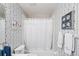 Full bathroom with a tub and shower featuring floral wallpaper and decor at 4563 Whirlaway Dr # C, Sarasota, FL 34233