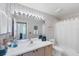 Full bathroom with a tub and shower featuring floral wallpaper and a large mirror at 4563 Whirlaway Dr # C, Sarasota, FL 34233