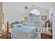 Comfortable bedroom featuring a large window, ceiling fan and vaulted ceiling at 4563 Whirlaway Dr # C, Sarasota, FL 34233