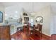 Dining area with wood table and chairs, open to the kitchen, and flooded with natural light at 4563 Whirlaway Dr # C, Sarasota, FL 34233