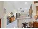 Bright kitchen features an island, stainless steel refrigerator, and white tile flooring at 4563 Whirlaway Dr # C, Sarasota, FL 34233