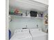 Convenient laundry room featuring a washer, dryer, and shelving for storage at 4563 Whirlaway Dr # C, Sarasota, FL 34233