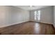 Light-filled bedroom features wood-look flooring, ceiling fan and window at 5115 Island Date Way, Sarasota, FL 34232