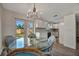 Charming dining area with white cabinetry, a modern chandelier, and French doors leading to the outside at 5115 Island Date Way, Sarasota, FL 34232
