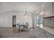 Bright open-concept dining room featuring a round glass table, seating for four, and tile floors at 5115 Island Date Way, Sarasota, FL 34232