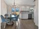 Bright dining area adjacent to a modern kitchen, featuring a glass table and access to the backyard at 5115 Island Date Way, Sarasota, FL 34232