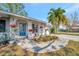 Lovely home with a blue front door and an eye-catching garden, enhancing its curb appeal at 5115 Island Date Way, Sarasota, FL 34232