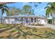 Charming single-story home featuring a well-manicured lawn and a welcoming front entrance at 5115 Island Date Way, Sarasota, FL 34232
