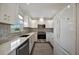 Bright kitchen featuring stainless steel appliances, quartz countertops, white cabinets, and modern finishes at 5115 Island Date Way, Sarasota, FL 34232