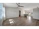 Bright and airy living room with modern flooring, a ceiling fan, and a view into the dining area at 5115 Island Date Way, Sarasota, FL 34232