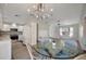 Open-concept living area featuring tile flooring, modern lighting, and a connection to the kitchen and dining spaces at 5115 Island Date Way, Sarasota, FL 34232
