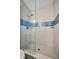 Shower features decorative blue-toned horizontal tile at 5115 Island Date Way, Sarasota, FL 34232