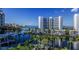 A beautiful waterfront view featuring tropical landscaping and modern architecture at 555 Quay Cmn # 401, Sarasota, FL 34236