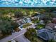 Aerial shot displaying neighborhood homes, manicured lawns, mature landscaping, and quiet street access at 6145 Bonaventure Ct, Sarasota, FL 34243
