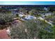 Aerial shot of a neighborhood with tree-lined streets, screened-in pools, and landscaped yards on a clear, sunny day at 6145 Bonaventure Ct, Sarasota, FL 34243