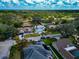Scenic aerial view of homes in a lush, green neighborhood under a bright blue sky with scattered clouds at 6145 Bonaventure Ct, Sarasota, FL 34243