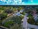 Aerial shot displays homes with well-kept lawns, mature trees, and a road winding through a serene residential neighborhood at 6145 Bonaventure Ct, Sarasota, FL 34243