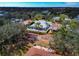 Aerial view of a home featuring a screened-in pool, mature trees, and well-kept landscaping in a serene neighborhood at 6145 Bonaventure Ct, Sarasota, FL 34243