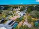 Aerial view of a residential neighborhood featuring houses with screened-in pools and lush green landscaping on a sunny day at 6145 Bonaventure Ct, Sarasota, FL 34243