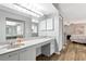 Bathroom featuring a white vanity with stone countertop, mirror, and lighting at 6145 Bonaventure Ct, Sarasota, FL 34243