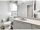 Bright bathroom featuring a white vanity with stone countertop, toilet, and neutral paint at 6145 Bonaventure Ct, Sarasota, FL 34243