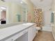 Bathroom with a full mirror and a tub-shower combo with colorful curtain and plenty of storage at 6145 Bonaventure Ct, Sarasota, FL 34243