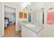 Bathroom with neutral color, large vanity mirror, adjacent bedroom, and good lighting at 6145 Bonaventure Ct, Sarasota, FL 34243