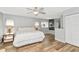 Bright bedroom with wood-look floors, ceiling fan, neutral paint, and large windows at 6145 Bonaventure Ct, Sarasota, FL 34243