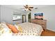 Bright bedroom with hardwood floors, ceiling fan, and a dresser with beachy sunset art at 6145 Bonaventure Ct, Sarasota, FL 34243