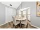Cozy dining area with a round table, four chairs, and a window overlooking the yard, perfect for intimate meals at 6145 Bonaventure Ct, Sarasota, FL 34243