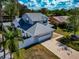 Two-story home with a gray roof, white fence, and a spacious driveway leading to a multi-car garage at 6145 Bonaventure Ct, Sarasota, FL 34243