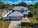 Home with a well-manicured lawn and a charming screened-in porch, next to the attached garage at 6145 Bonaventure Ct, Sarasota, FL 34243