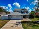 Well-maintained two-story home with a large garage and landscaped front yard under a bright, cloudy sky at 6145 Bonaventure Ct, Sarasota, FL 34243