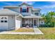 Inviting home entrance featuring a charming screened-in porch and lush landscaping at 6145 Bonaventure Ct, Sarasota, FL 34243