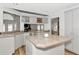 Bright kitchen with a center island, wraparound countertop, and views into the living area at 6145 Bonaventure Ct, Sarasota, FL 34243