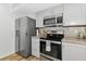 Well-equipped kitchen features stainless steel appliances and gray cabinets with ample storage at 6145 Bonaventure Ct, Sarasota, FL 34243