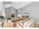 Comfortable living room featuring a fireplace, high ceilings, and open layout at 6145 Bonaventure Ct, Sarasota, FL 34243