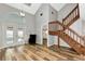 Open concept living room featuring wood-look floors, staircase, and access to a pool view at 6145 Bonaventure Ct, Sarasota, FL 34243