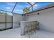 Outdoor bar area in screened-in lanai provides an entertaining space for gathering with friends at 6145 Bonaventure Ct, Sarasota, FL 34243