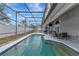 Inviting screened-in pool area with lounge chairs and dining offers great space for outdoor entertainment at 6145 Bonaventure Ct, Sarasota, FL 34243