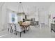 Elegant dining area featuring modern lighting, a view to the kitchen, and neutral decor at 6223 Champions Row St, Bradenton, FL 34210