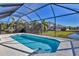 Backyard pool with a screened-in enclosure and waterfront view, perfect for relaxation and outdoor enjoyment at 6223 Champions Row St, Bradenton, FL 34210