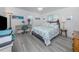 Bright bedroom with gray flooring, desk, and light gray upholstered bed frame at 641 Verrocchio Dr, Nokomis, FL 34275