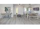Inviting dining area with modern decor, stylish lighting, and sleek flooring at 641 Verrocchio Dr, Nokomis, FL 34275