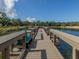 Scenic view of a dock overlooking a tranquil lake and lush greenery at 641 Verrocchio Dr, Nokomis, FL 34275